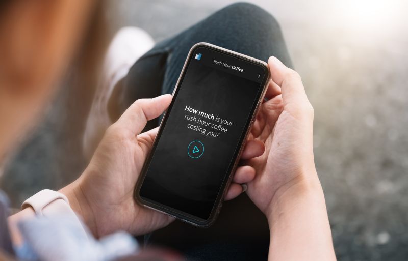 Man holding phone with coffee application